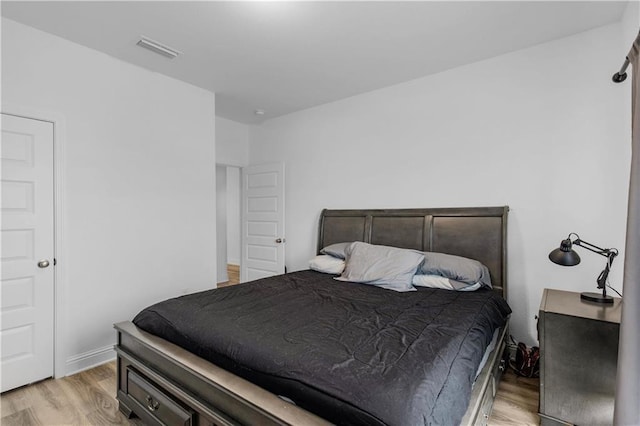 bedroom featuring visible vents and light wood-style flooring