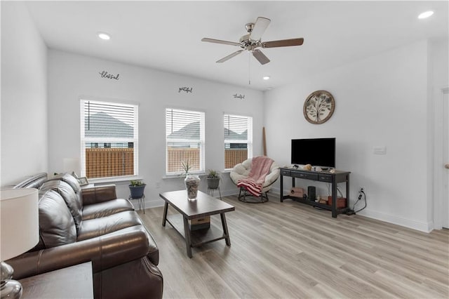 living room featuring light wood-style floors, recessed lighting, baseboards, and a ceiling fan