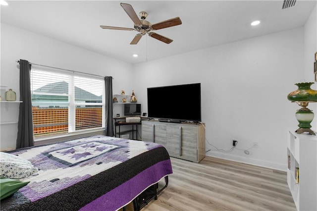 bedroom with recessed lighting, wood finished floors, visible vents, and baseboards