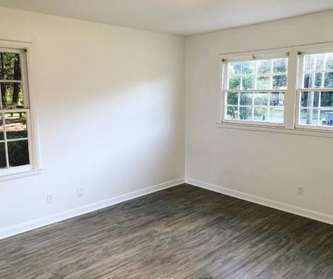 spare room featuring dark hardwood / wood-style floors