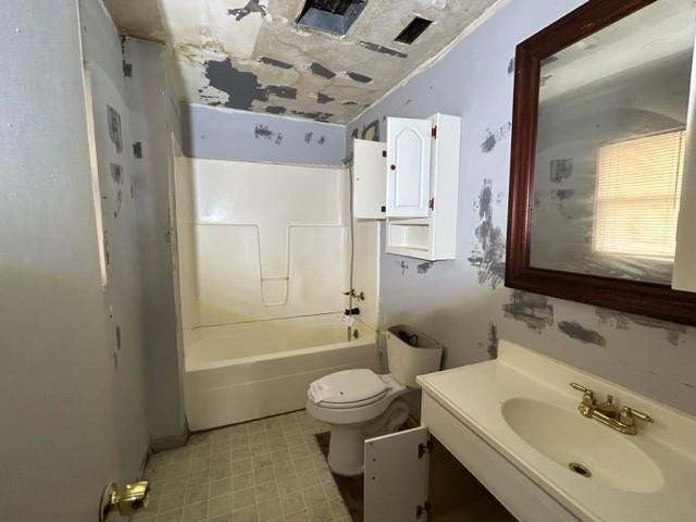 full bathroom featuring bathing tub / shower combination, vanity, and toilet