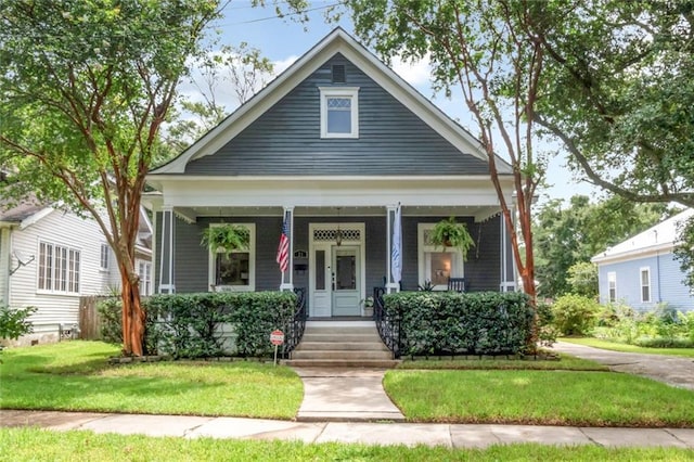 view of front of house featuring a porch and a front yard