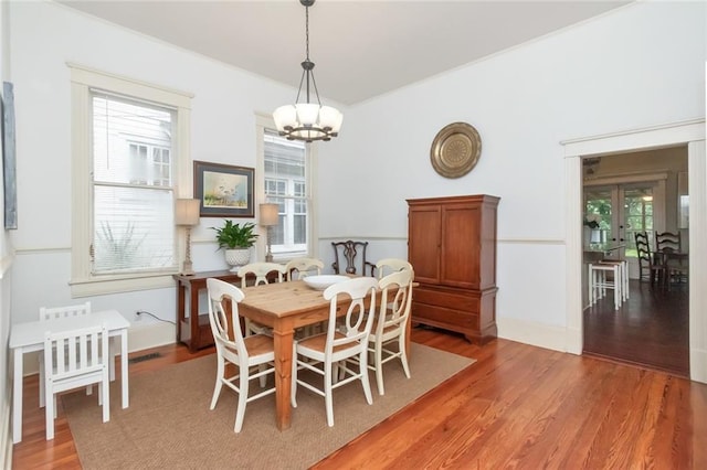 dining area featuring a notable chandelier and wood-type flooring