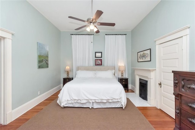 bedroom with light hardwood / wood-style flooring and ceiling fan