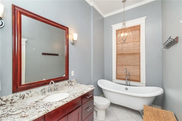 bathroom with vanity, crown molding, toilet, tile patterned flooring, and a bath