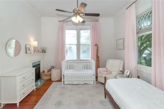 bedroom featuring wood-type flooring and ceiling fan