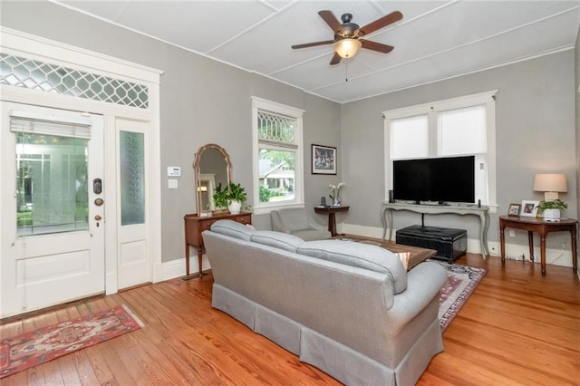 living room with light hardwood / wood-style floors and ceiling fan