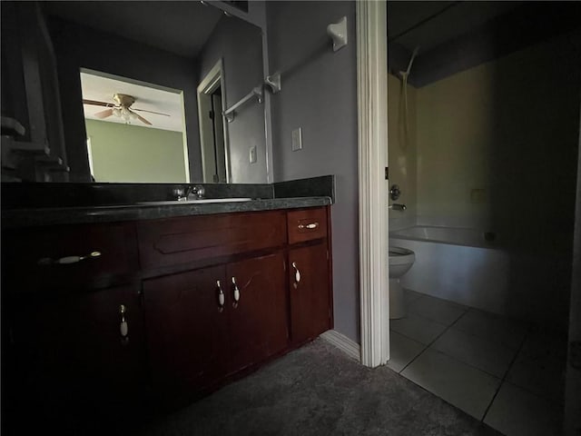 full bathroom featuring vanity, ceiling fan, washtub / shower combination, tile patterned flooring, and toilet