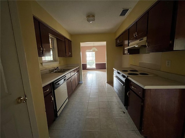 kitchen with dark brown cabinetry, sink, electric range oven, white dishwasher, and light tile patterned floors