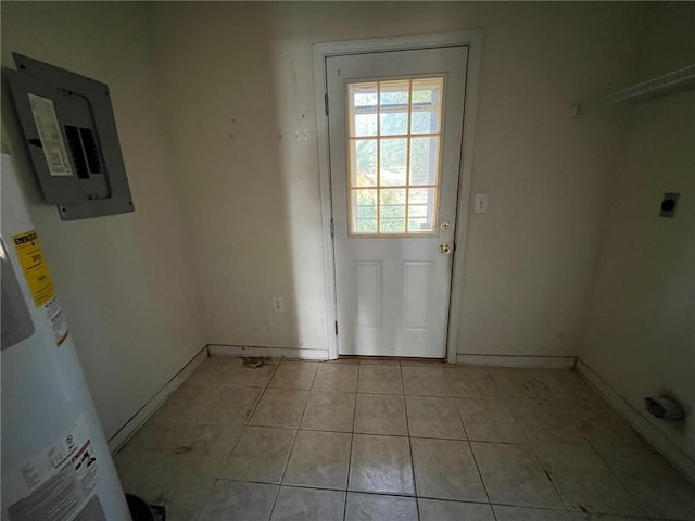 doorway to outside featuring light tile patterned flooring, electric panel, and water heater