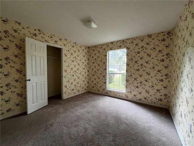 unfurnished bedroom with a closet and carpet floors