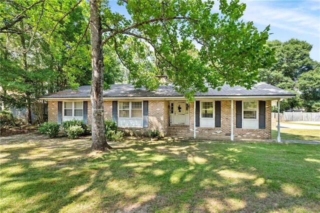 ranch-style home with covered porch and a front lawn