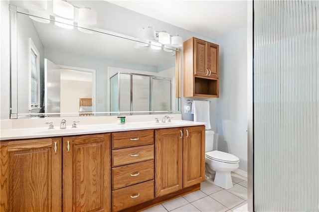 bathroom with tile patterned flooring, toilet, and dual bowl vanity