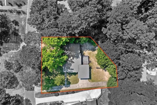 rear view of house with a wooden deck and a lawn