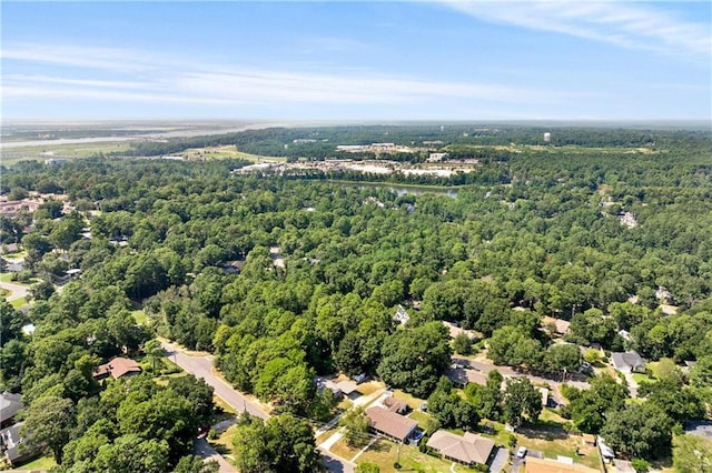 birds eye view of property with a view of trees