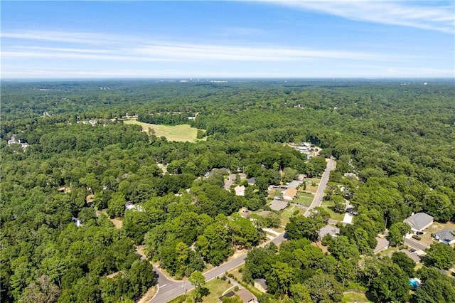 birds eye view of property with a view of trees