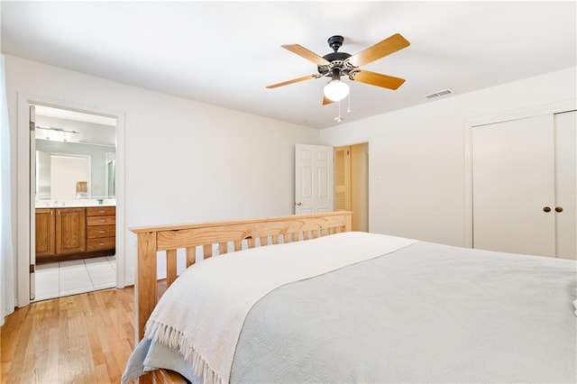 tiled bedroom featuring a closet, ceiling fan, and ensuite bathroom