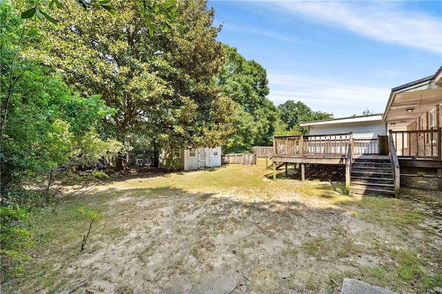 view of yard with stairway and a deck