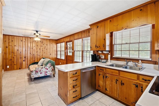 kitchen featuring light countertops, open floor plan, a sink, dishwasher, and a peninsula