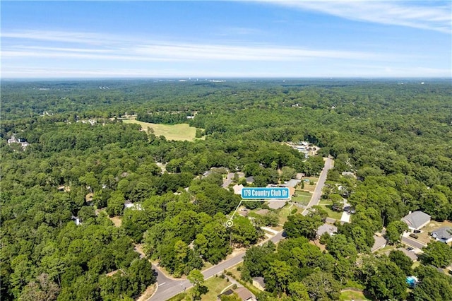 birds eye view of property featuring a forest view