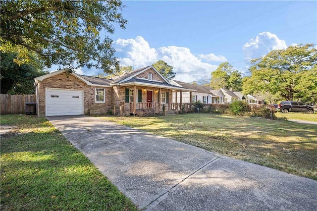 view of front of house with covered porch, a front yard, and a garage