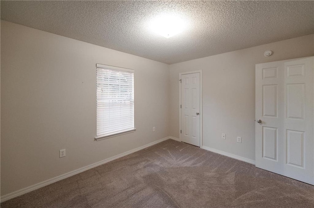 spare room with carpet floors and a textured ceiling