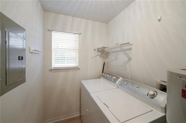 laundry room featuring a textured ceiling, electric panel, water heater, and washing machine and clothes dryer