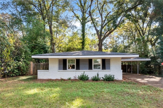 view of front of property with a front lawn and a carport