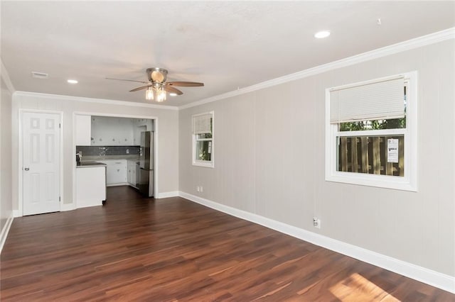 unfurnished living room featuring dark hardwood / wood-style flooring, ceiling fan, and ornamental molding