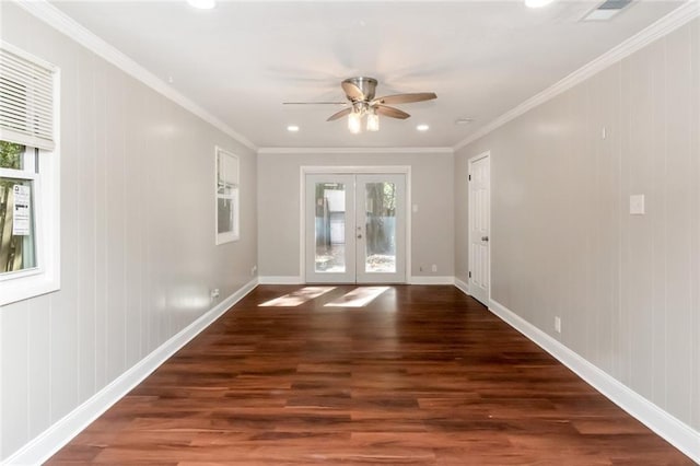 entryway with ceiling fan, french doors, dark hardwood / wood-style floors, wood walls, and ornamental molding