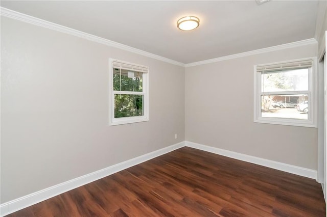 spare room featuring crown molding and dark hardwood / wood-style floors