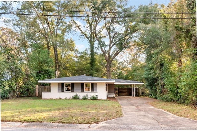 view of front facade with a front yard and a carport