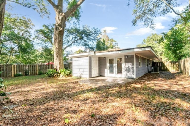 back of property featuring central AC and french doors