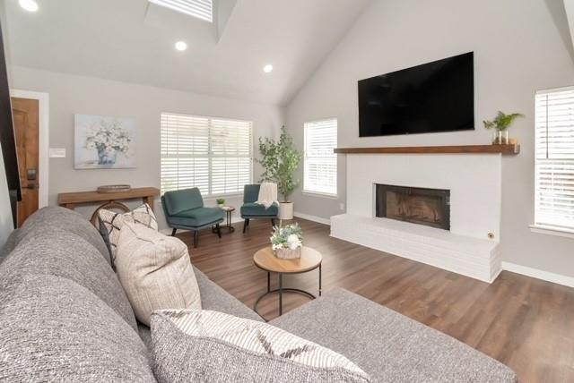 3132 Wellborne Dr W, Mobile, AL 36695 - living area featuring wood finished floors, high vaulted ceiling, plenty of natural light, a fireplace with raised hearth, and recessed lighting