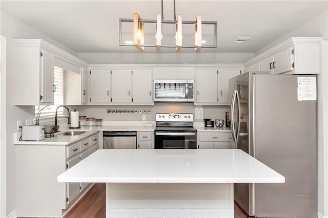 3132 Wellborne Dr W, Mobile, AL 36695 - kitchen with stainless steel appliances, light countertops, a kitchen island, and white cabinetry