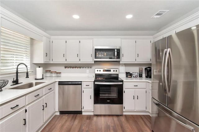 3132 Wellborne Dr W, Mobile, AL 36695 - kitchen with appliances with stainless steel finishes, light countertops, white cabinets, and recessed lighting
