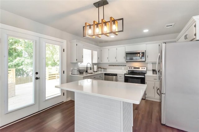 3132 Wellborne Dr W, Mobile, AL 36695 - kitchen featuring stainless steel appliances, french doors, a chandelier, dark wood finished floors, and recessed lighting