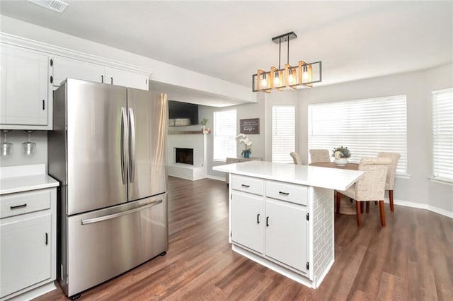 3132 Wellborne Dr W, Mobile, AL 36695 - kitchen with freestanding refrigerator, dark wood finished floors, light countertops, and white cabinets