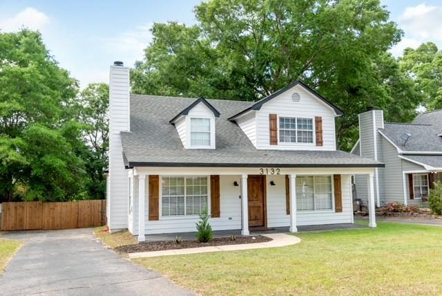 3132 Wellborne Dr W, Mobile, AL 36695 - view of front facade with a porch, a chimney, and roof with shingles