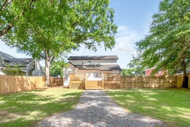 3132 Wellborne Dr W, Mobile, AL 36695 - back of property with a fenced backyard and a deck