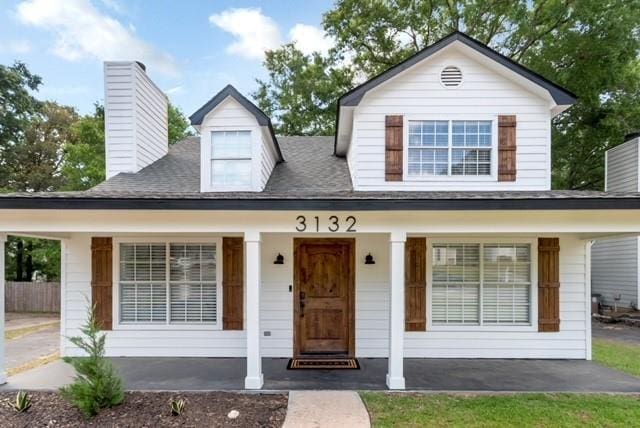 3132 Wellborne Dr W, Mobile, AL 36695 - view of front of house with a porch, a chimney, and roof with shingles