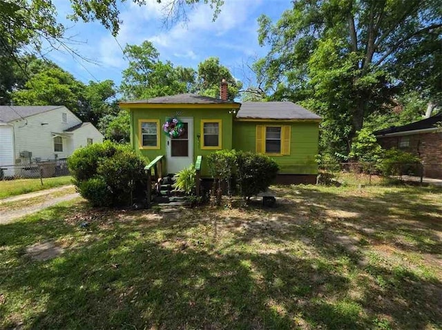bungalow-style house with a chimney and entry steps