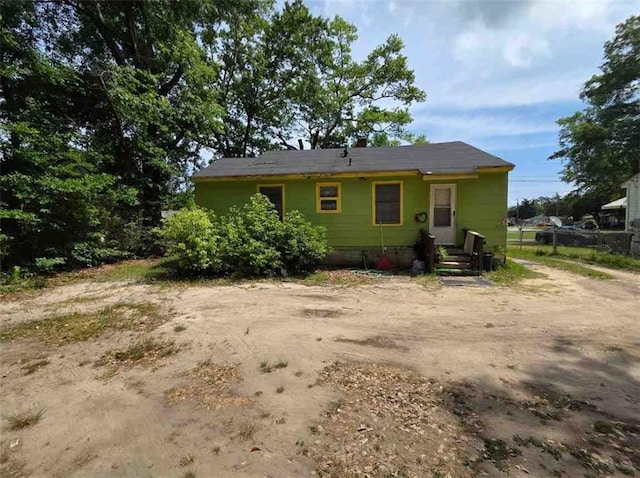 rear view of property with fence