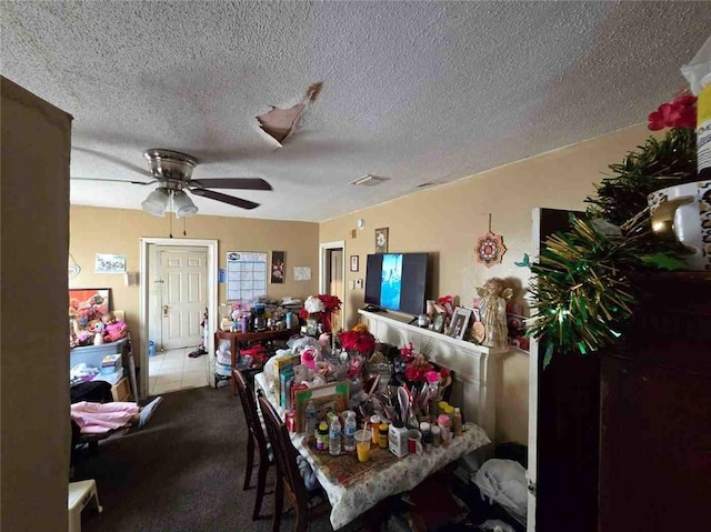 dining area with ceiling fan, a textured ceiling, and carpet floors