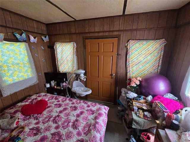 bedroom featuring wood walls