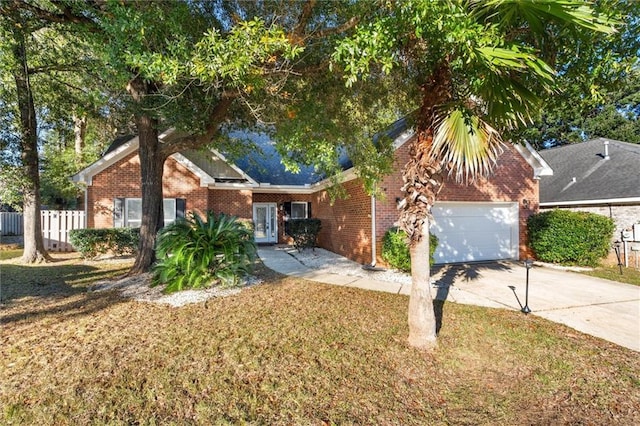 view of front of home featuring a garage and a front lawn