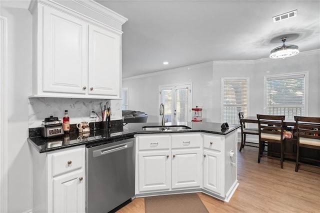 kitchen featuring white cabinets, stainless steel dishwasher, a healthy amount of sunlight, and sink