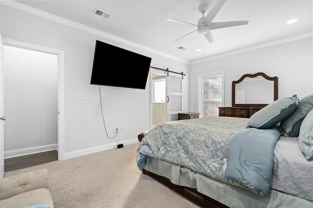 carpeted bedroom with ceiling fan and ornamental molding