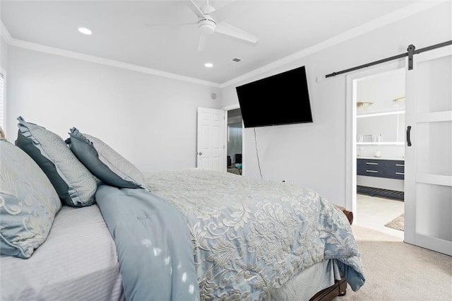 bedroom with light carpet, ceiling fan, a barn door, ornamental molding, and connected bathroom