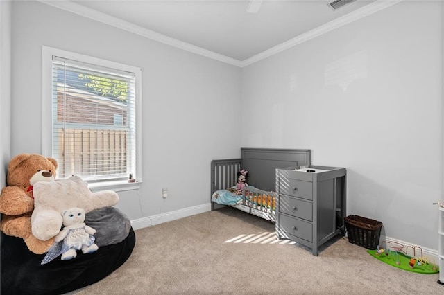 bedroom featuring ceiling fan, carpet floors, crown molding, and a nursery area